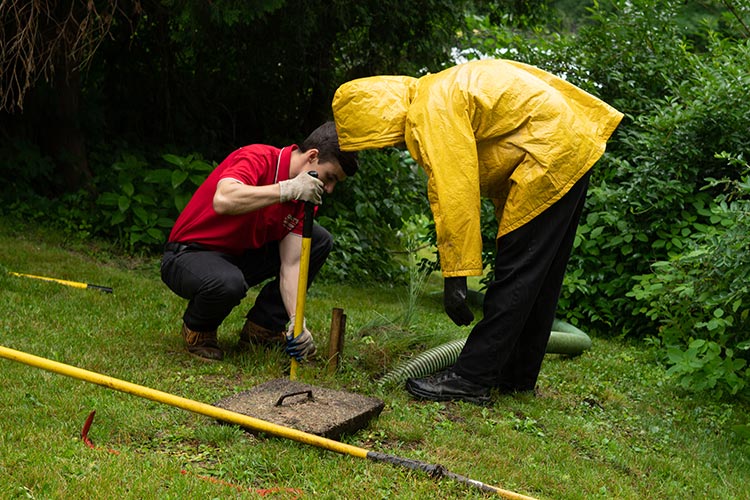 Checking a septic system in the rain