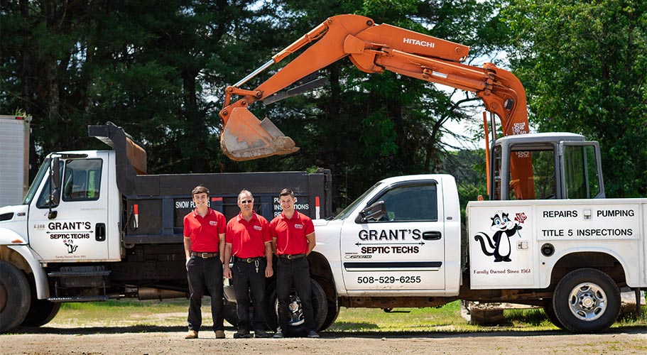 The Grants in front of their septic system equipment for replacement or repair