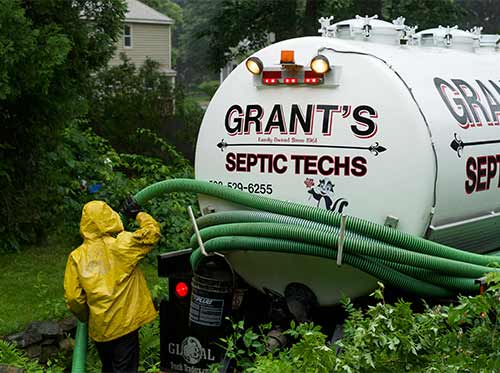 emergency septic pumping in action on a rainy day